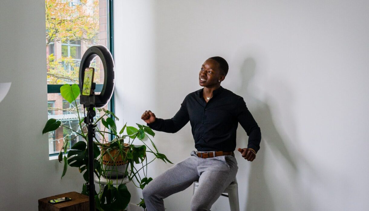 Man recording video with a smartphone and ring light