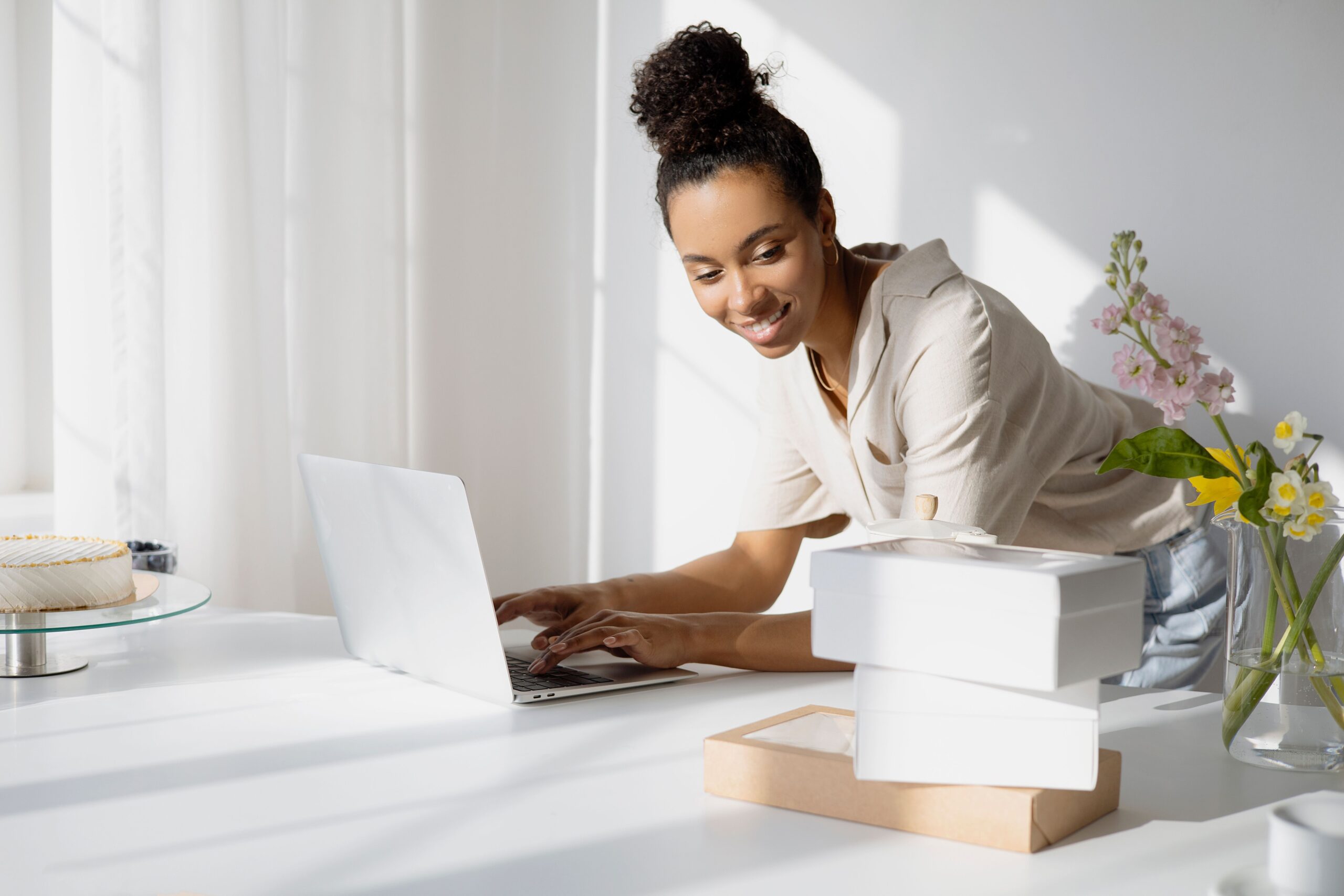 African American woman working on a laptop managing her small business