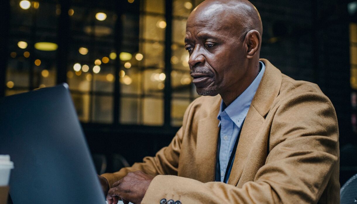 Man working on a laptop in a cafe