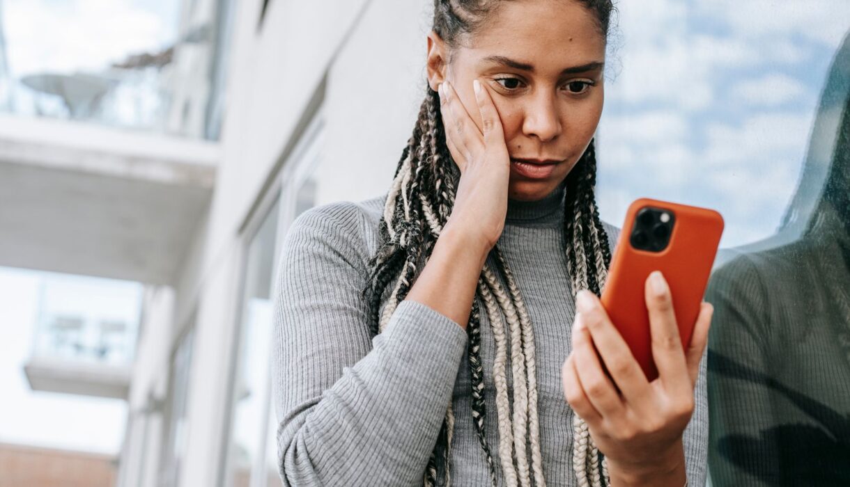 Woman looking carefully at her smartphone screen