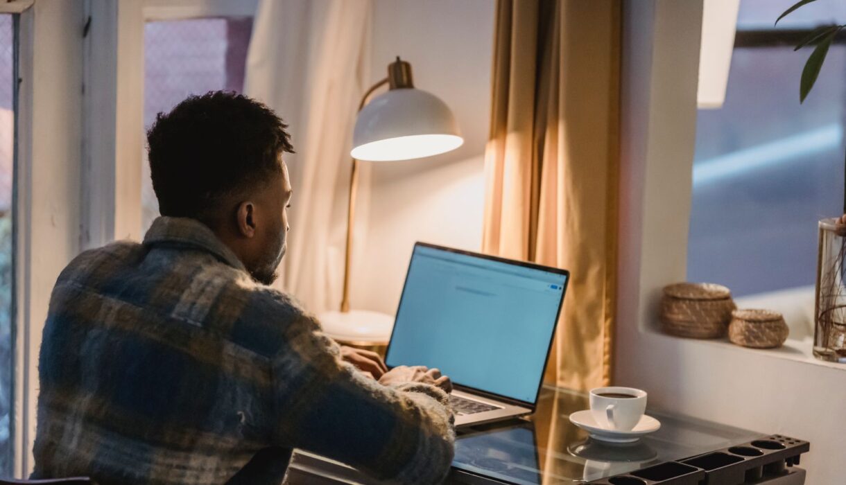 Young man focused on his laptop while searching for jobs online